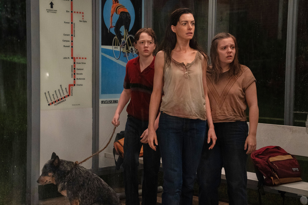 This image released by Warner Bros. Pictures shows Christian Convery, from left, Anne Hathaway and Maisy Stella in a scene from "The End of Oak Street." (Warner Bros. Pictures via AP)