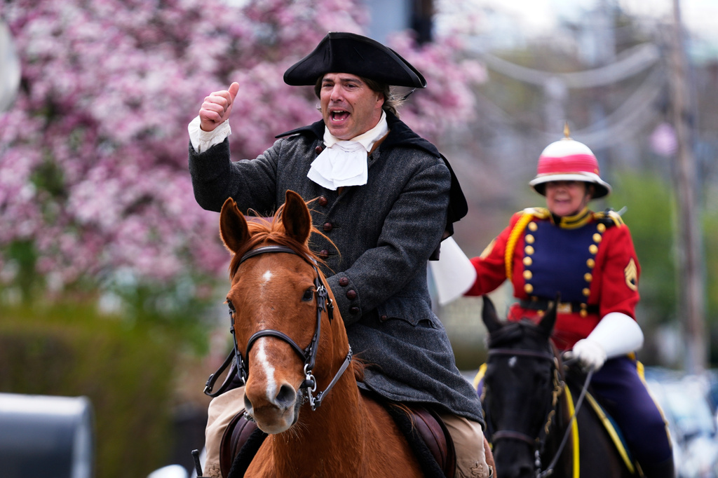 Brig. Gen. Richard Reale, dressed as American patriot Paul Revere, left, and outrider Cyndi Sumner reenact the 1775 Boston-to-Lexington ride to alert colonists of approaching British troops, Monday, April 20, 2026, in Somerville, Mass. (AP Photo/Robert F. Bukaty)