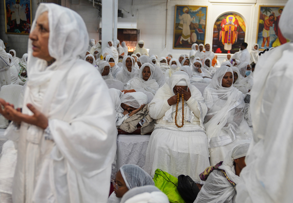 Women pray during the overnight Easter service at Re'ese Adbarat Debre Selam Kidist Mariam Church, an Ethiopian Orthodox Tewahedo church, in Washington, Saturday, April 11, 2026. (AP Photo/Jessie Wardarski)