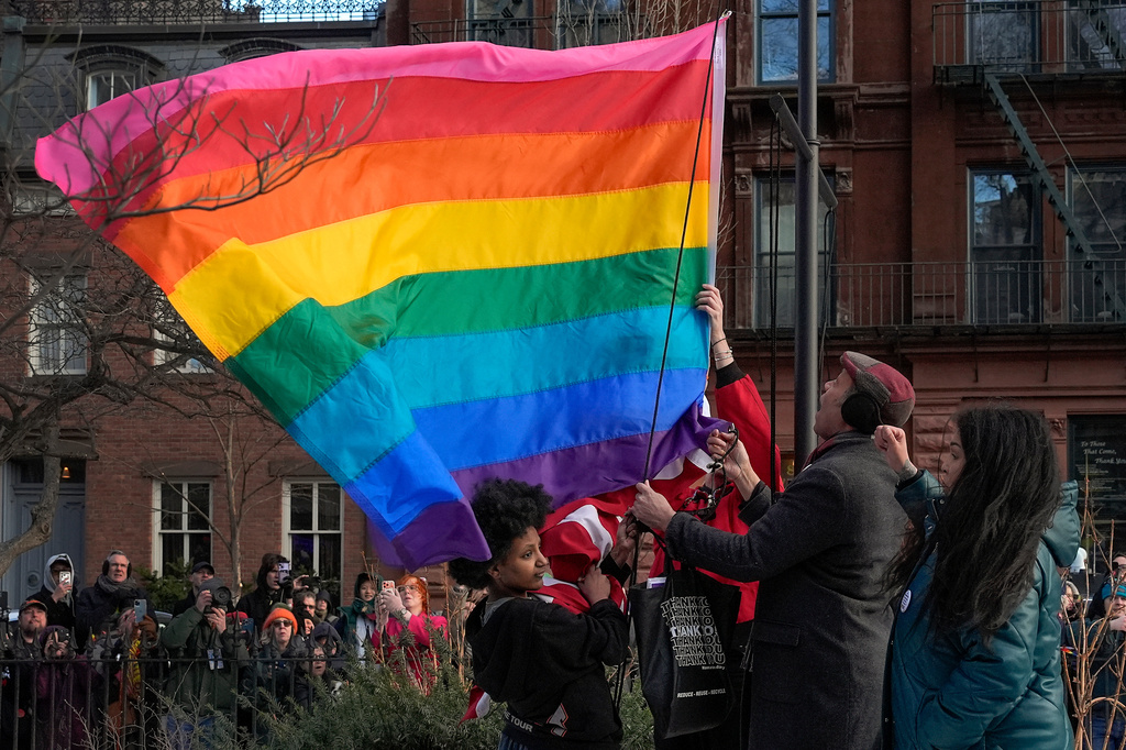 FILE - New York politicians and activists raise a rainbow flag on a pole in Christopher Park across the street from the Stonewall Inn, Thursday, Feb. 12, 2026, in New York, a few days after it was removed by the National Park Service to comply with guidance from the Trump administration. (AP Photo/Yuki Iwamura, File)