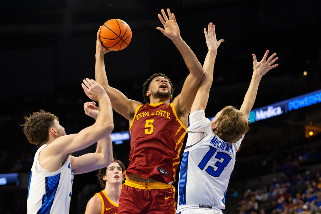 Iowa State forward Joshua Jefferson (5) pulls down the ball against Creighton forward Liam McChesney (13) during the second half of an NCAA college basketball exhibition game, Friday, Oct. 17, 2025, in Omaha, Neb. (AP Photo/Bonnie Ryan)