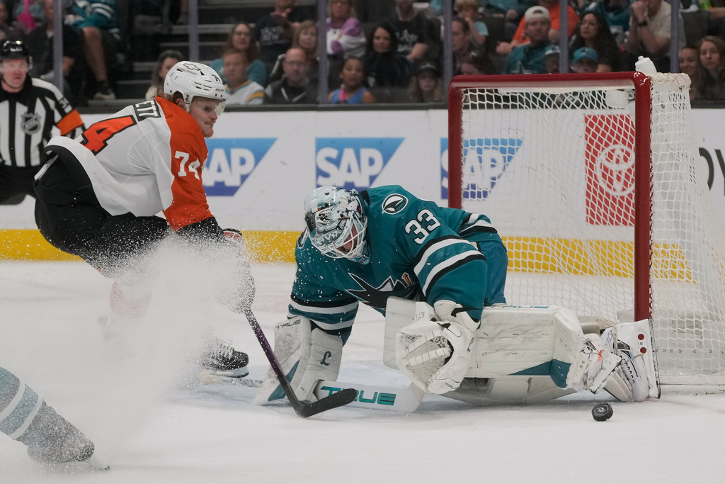 San Jose Sharks goaltender Alex Nedeljkovic (33) defends against a shot by Philadelphia Flyers right wing Owen Tippett (74) during the second period of an NHL hockey game in San Jose, Calif., Saturday, March 21, 2026. (AP Photo/Jeff Chiu)