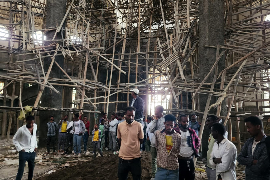 Worshippers stand inside the Menjar Shenkora Arerti Mariam Church under construction that collapsed in Arerti, Amhara region of northern Ethiopia, on Wednesday, Oct. 1, 2025. (AP Photo/Samuel Getachew)