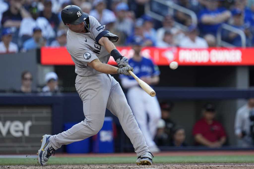 New York Yankees' Paul Goldschmidt hits a two-run home run against the Toronto Blue Jays during the ninth inning of a baseball game in Toronto, Saturday, June 13, 2026. (Frank Gunn/The Canadian Press via AP)