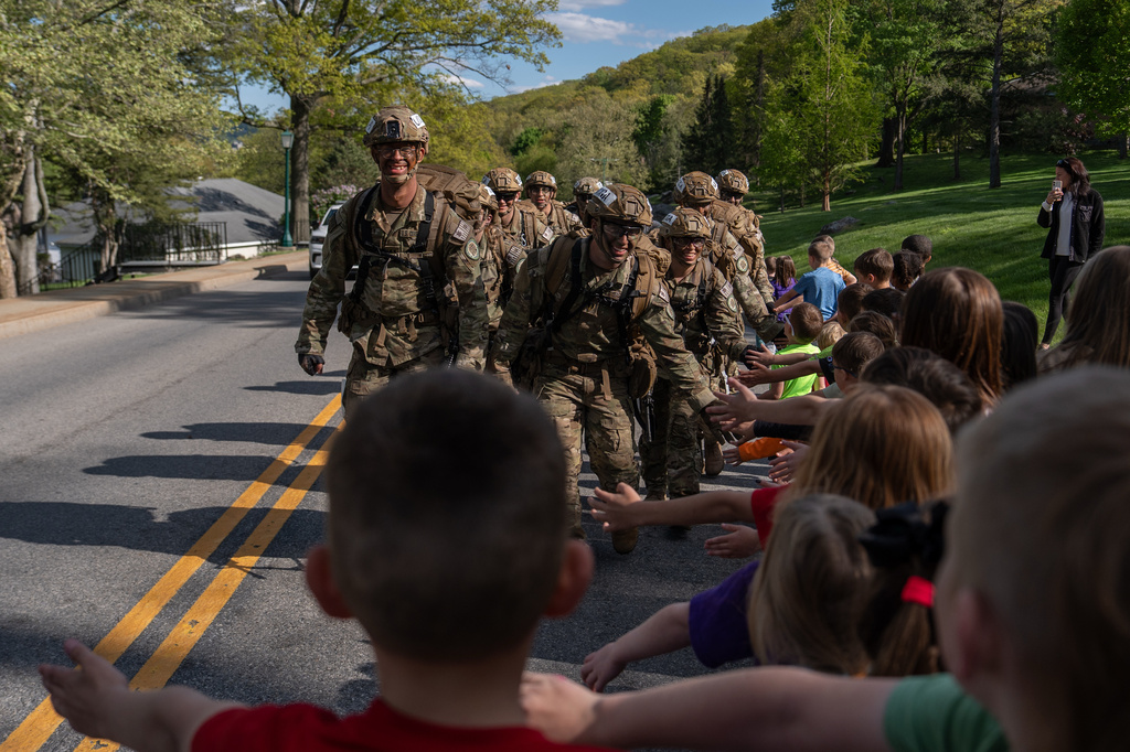 Cadets high five kids while competing in a timed eight mile ruck during the Sandhurst Military Skills Competition at the United States Military Academy in West Point, N.Y., Friday, May 1, 2026. (AP Photo/Julia Demaree Nikhinson)