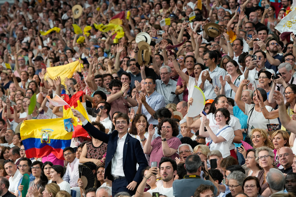 People react as Pope Leo XIV arrives on the occasion of a meeting with the diocesan community at the Santiago Bernabeu stadium in Madrid, Spain, Monday, June 8, 2026. (AP Photo/Bernat Armangue)