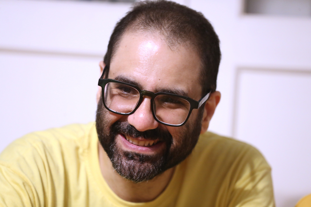 Pro-democracy activist Alaa Abd el-Fattah, who was in prison for almost all of the past 12 years, speaks to his friends at his home after he got a presidential pardon, in Cairo, Tuesday, Sept. 23, 2025. (AP Photo/Khaled Elfiqi)