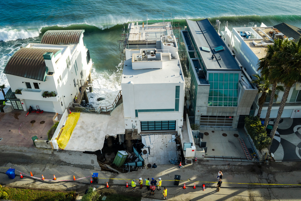 An aerial view of a sinkhole which collapsed the driveway of a coastal mansion owned by actor Nicolas Cage Tuesday, Sept. 8, 2026, in Malibu, Calif. (AP Photo/Ethan Swope)