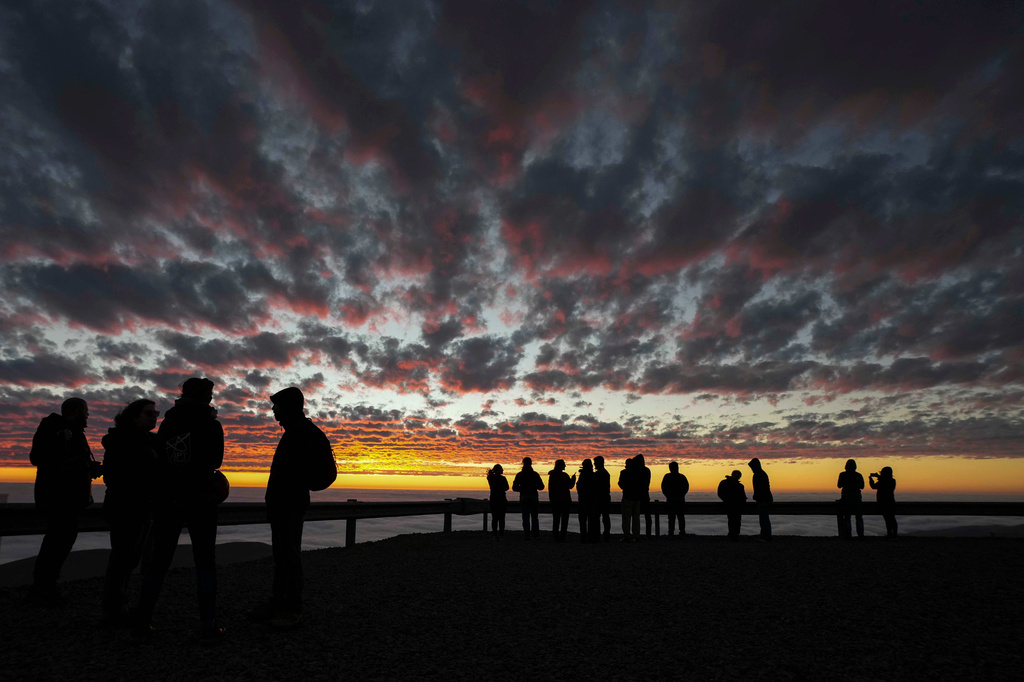 Astronomers are silhouetted against the sunset sky at Paranal Observatory in the Atacama Desert, Chile, Tuesday, April 14, 2026. (AP Photo/Esteban Felix)