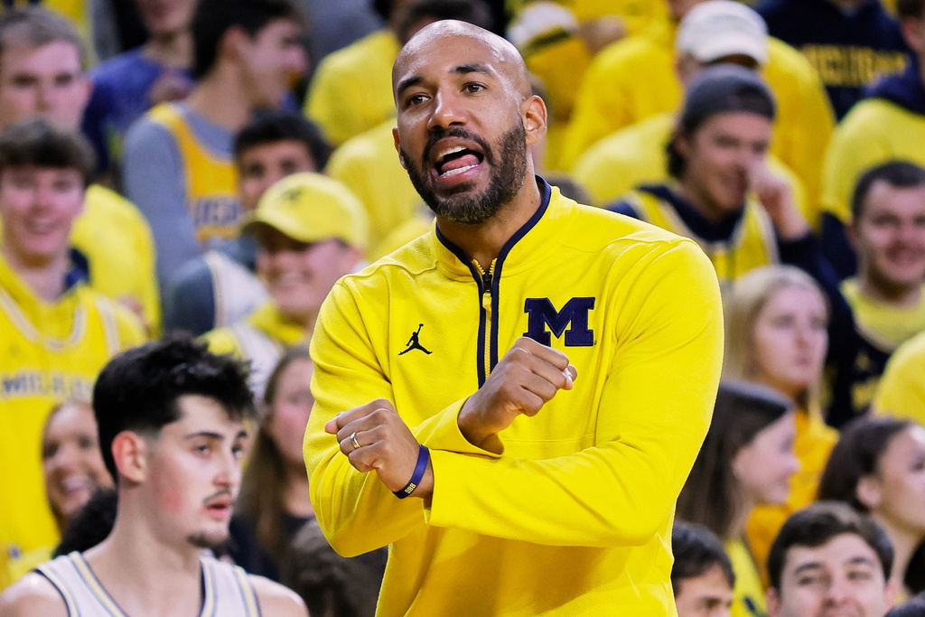FILE - Michigan assistant coach Justin Joyner gestures to an official during the first half of an NCAA college basketball game against Rutgers, Dec. 6, 2025, in Ann Arbor, Mich. (AP Photo/Duane Burleson, File)