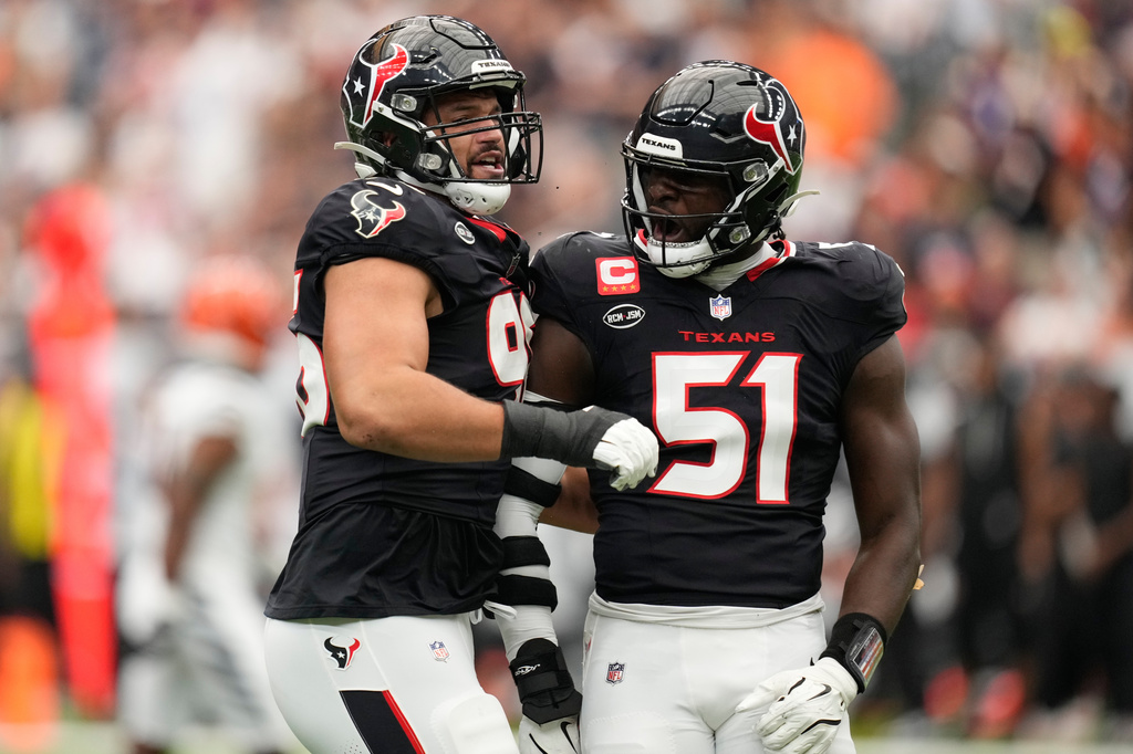 Houston Texans defensive end Logan Hall (96), and defensive end Will Anderson Jr. (51), celebrate after sacking Cincinnati Bengals quarterback Joe Burrow during the first half of an NFL football game in Houston, Sunday, Sept. 20, 2026. (AP Photo/Ashley Landis)