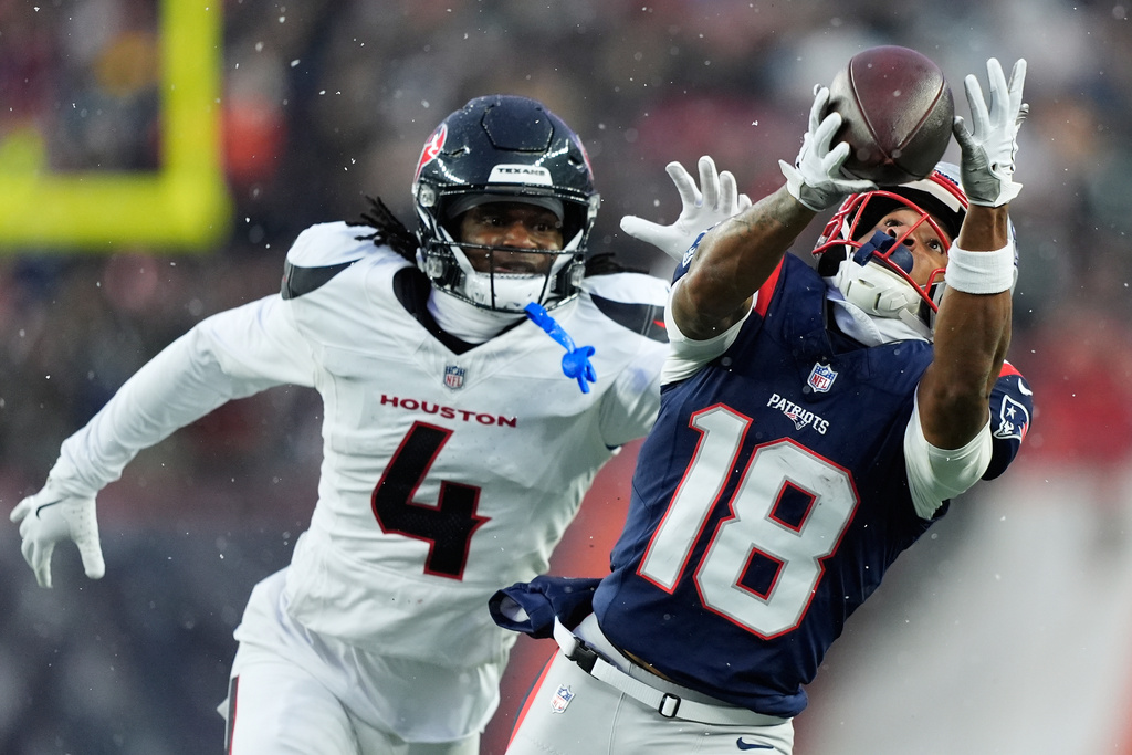 New England Patriots wide receiver Kyle Williams (18) cannot catch a pass against Houston Texans cornerback Kamari Lassiter (4) during the first half of an NFL divisional playoff football game, Sunday, Jan. 18, 2026, in Foxborough, Mass. (AP Photo/Robert F. Bukaty)