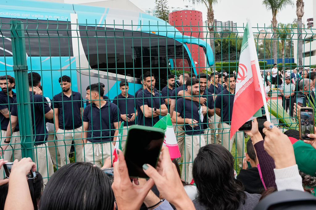 Fans greet members of the Iran World Cup soccer team as they leave their hotel for the airport Tuesday, June 30, 2026, in Tijuana, Mexico. (AP Photo/Gregory Bull)