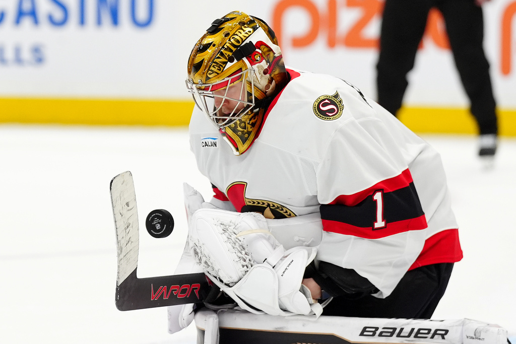 Ottawa Senators goaltender Leevi Meriläinen (1) makes a save during the second period of an NHL hockey game against the Toronto Maple Leafs in Toronto, Saturday, Dec. 27, 2025. (Frank Gunn/The Canadian Press via AP)