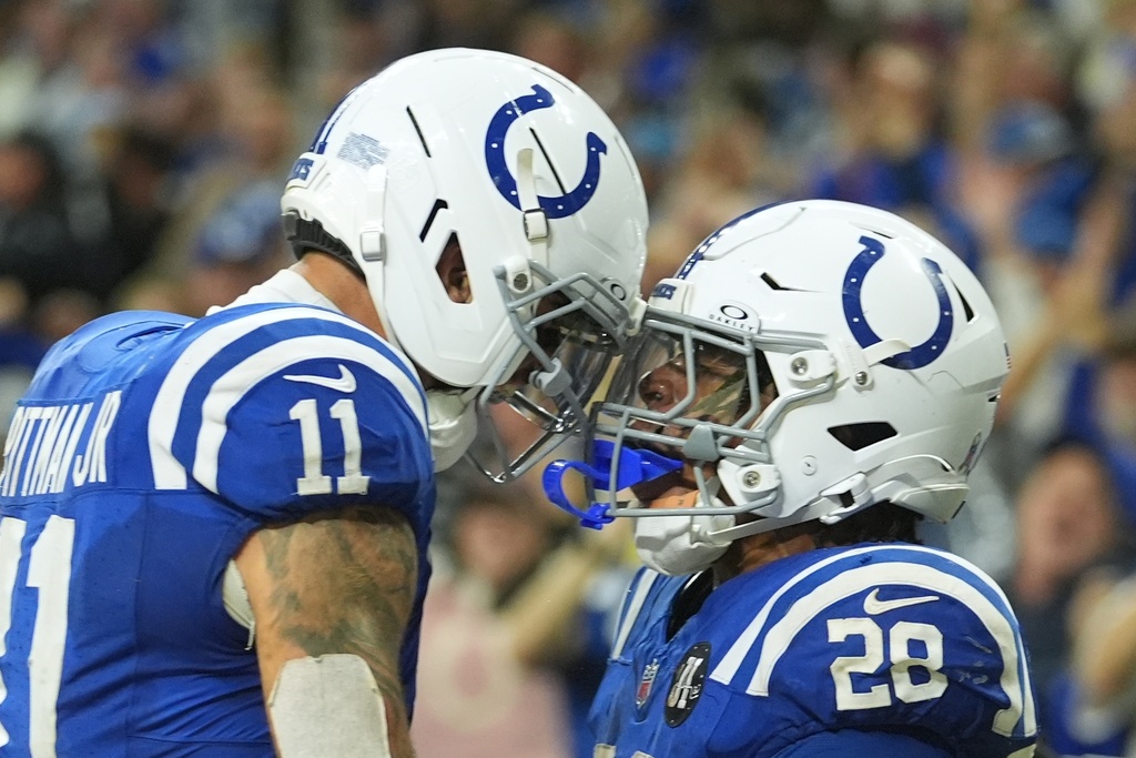 Indianapolis Colts running back Jonathan Taylor (28) celebrates a touchdown with wide receiver Michael Pittman Jr. during the second half an NFL football game against the Tennessee Titans, Sunday, Oct. 26, 2025, in Indianapolis. (AP Photo/Michael Conroy)
