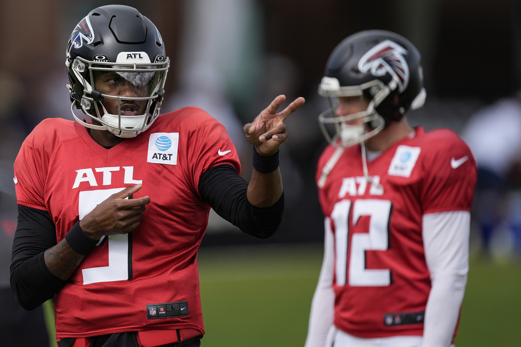 Atlanta Falcons quarterback Michael Penix Jr. (9) and Easton Stick (12) work out during a joint NFL football practice between the Atlanta Falcons and the Tennessee Titans, Wednesday, Aug. 13, 2025, in Flowery Branch, Ga. (AP Photo/Mike Stewart)