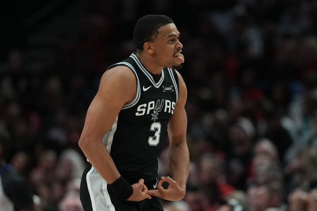 San Antonio Spurs forward Keldon Johnson (3) reacts after scoring against the Portland Trail Blazers during the second half in Game 3 of a first-round NBA playoffs basketball series in Portland, Ore, Friday, April 24, 2026. (AP Photo/Jenny Kane)
