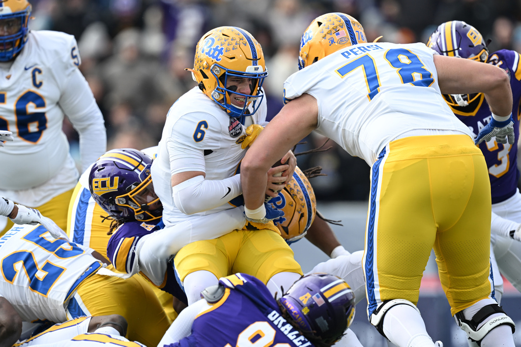 Pittsburgh quarterback Mason Heintschel (6) is sacked by East Carolina during the first half of the Military Bowl NCAA college football game, Saturday, Dec. 27, 2025, in Annapolis, Md. (AP Photo/Gail Burton)