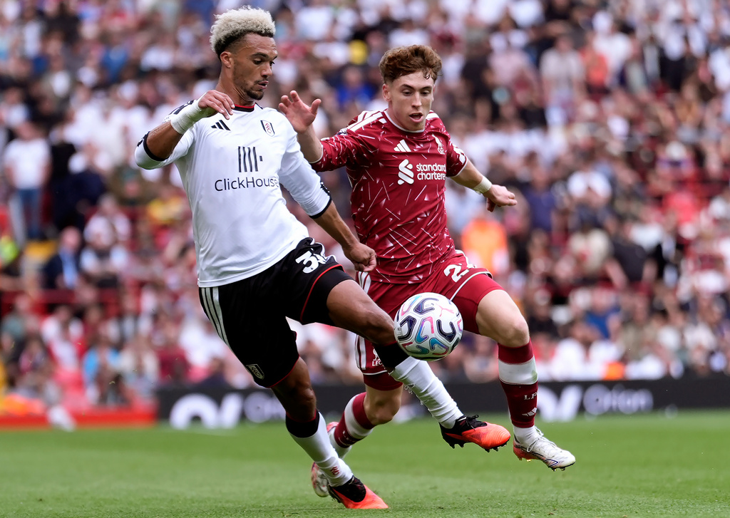 Fulham's Antonee Robinson, left, and Liverpool's Victor Munoz battle for the ball during the English Premier League soccer match between Liverpool and Fulham in Liverpool, England, Saturday Sept. 12, 2026. (Peter Byrne/PA via AP)
