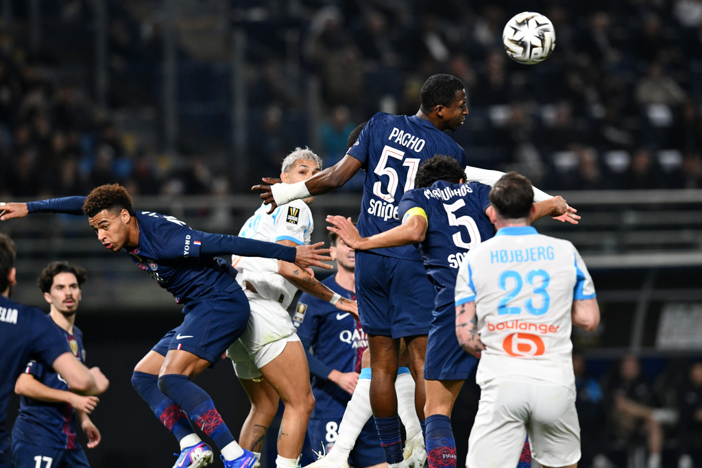 PSG's Willian Pacho heads the ball clear during the French Super Cup soccer match between PSG and Marseille in Kuwait City, Kuwait, Thursday, Jan. 8, 2026. (AP Photo/Jaber Abdulkhaleg)
