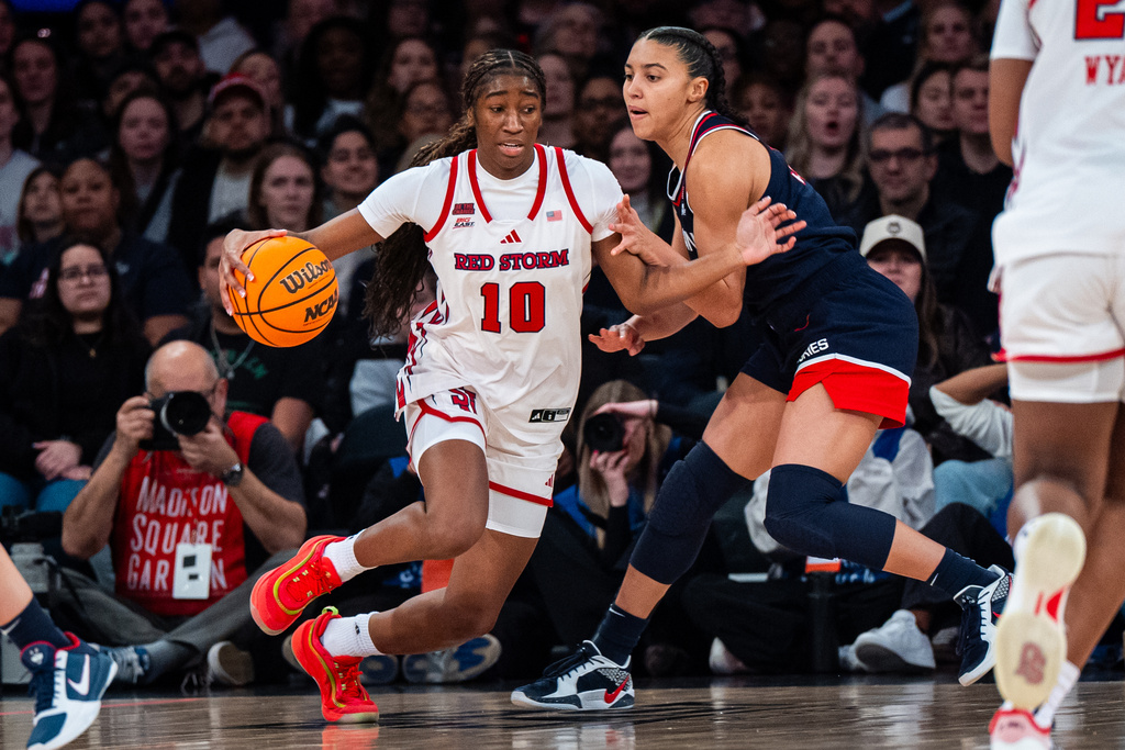 St. John's guard Brooke Moore (10), defended by UConn guard Azzi Fudd (35), searches for an opening to the basket during the first half of an NCAA college basketball game, Sunday, March 1, 2026, in New York. (AP Photo/Angelina Katsanis)