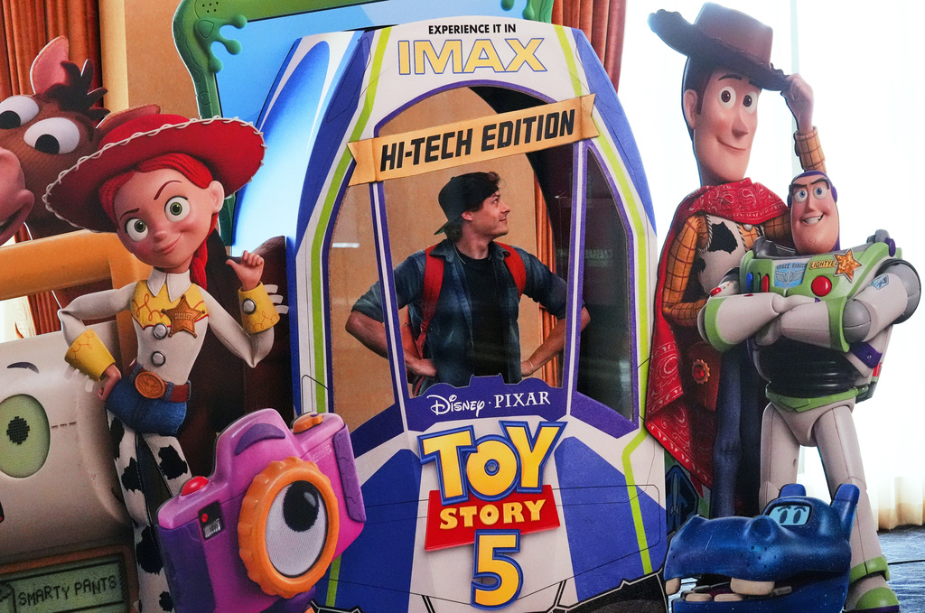 CinemaCon attendee Patrick Dougall strikes a pose inside an advertisement for the upcoming film "Toy Story 5" during the opening day of CinemaCon 2026, the official convention of Cinema United, on Monday, April 13, 2026, at Caesars Palace in Las Vegas. (AP Photo/Chris Pizzello)