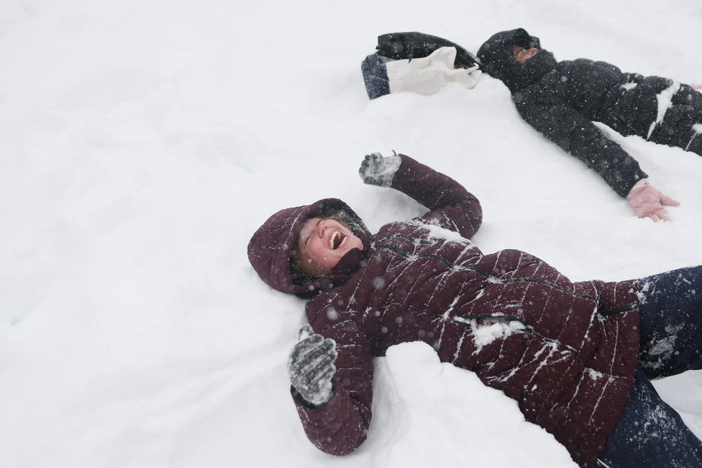 Sadie Eidson, left, laughs while playing in the snow in Central Park during a winter storm, Sunday, Jan. 25, 2026, in New York. (AP Photo/Heather Khalifa)