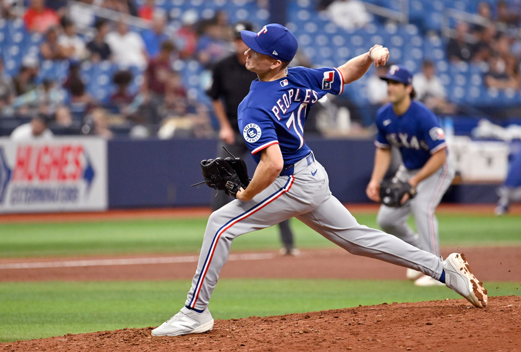 Texas Rangers pitcher Ben Peoples throws during the eighth inning of a baseball game against the Tampa Bay Rays, Thursday, July 30, 2026, in St. Petersburg, Fla. (AP Photo/Jason Behnken)