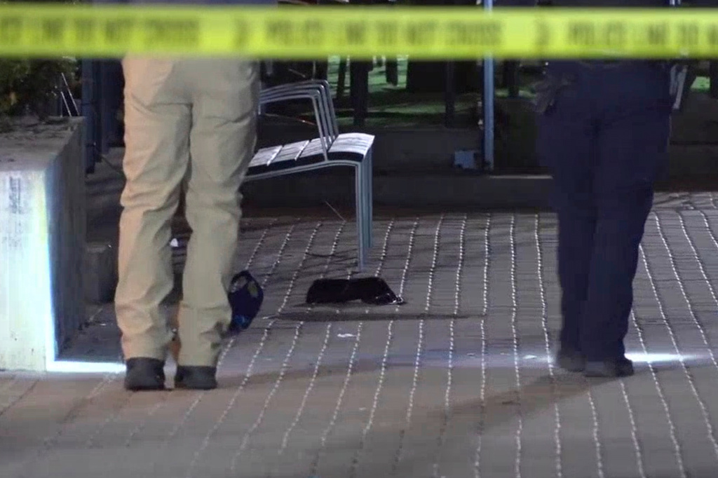 This image made from video provided by KCRG shows Iowa City police officers working the scene of a downtown shooting near the University of Iowa campus on Sunday, April 19, 2026. (KCRG via AP)