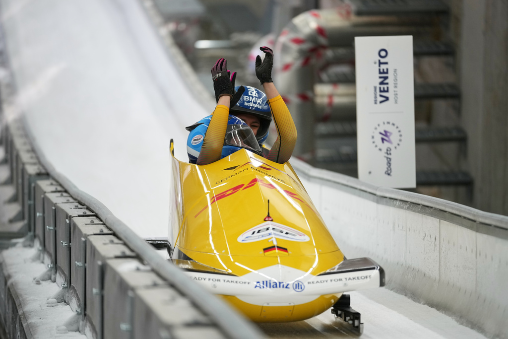 Laura Nolte and Deborah Levi, of Germany, celebrate when finishing their second run during the 2-woman bobsleigh World Cup and Olympic test event in Cortina D'Ampezzo, Italy, Sunday, Nov. 23, 2025. (AP Photo/Andrew Medichini)