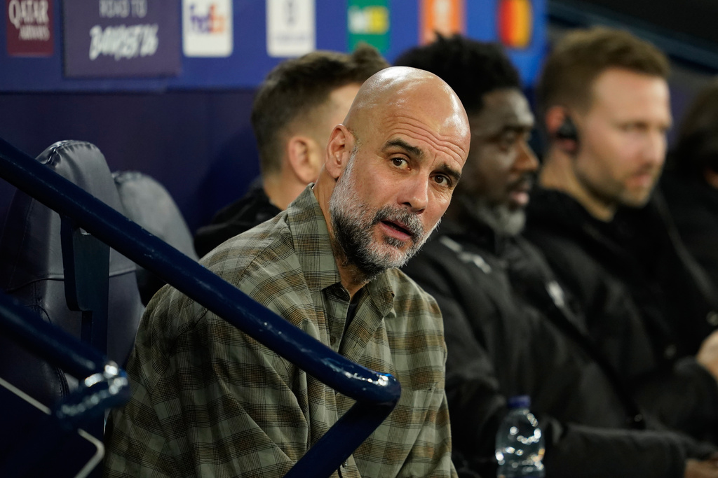 Manchester City's head coach Pep Guardiola watches from the bench ahead of the Champions League round of 16 second leg soccer match between Manchester City and Real Madrid in Manchester, Tuesday, March 17, 2026. (AP Photo/Dave Thompson)