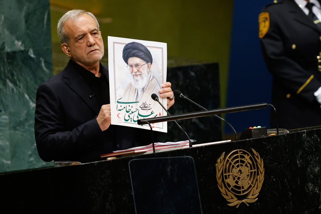 Iran's President Masoud Pezeshkian holds an image of late Iranian Supreme Leader Ayatollah Ali Khamenei during the 81st session of the United Nations General Assembly at United Nations headquarters, Wednesday, Sept. 23, 2026. (AP Photo/Stefan Jeremiah)
