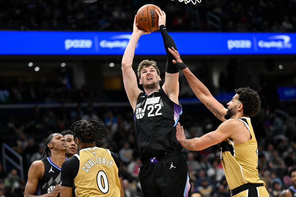 Utah Jazz forward Kyle Filipowski (22) goes to shoot against Washington Wizards forward Anthony Gill during the first half of an NBA basketball game, Thursday, March 5, 2026, in Washington. (AP Photo/John McDonnell)