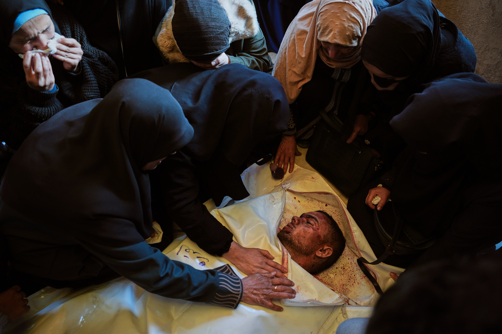Palestinians attend the funeral of Ahmed al-Qudra at Nasser Hospital in Khan Younis, Gaza Strip, after he was killed in an Israeli military strike, Tuesday, Jan. 6, 2026. (AP Photo/Abdel Kareem Hana)