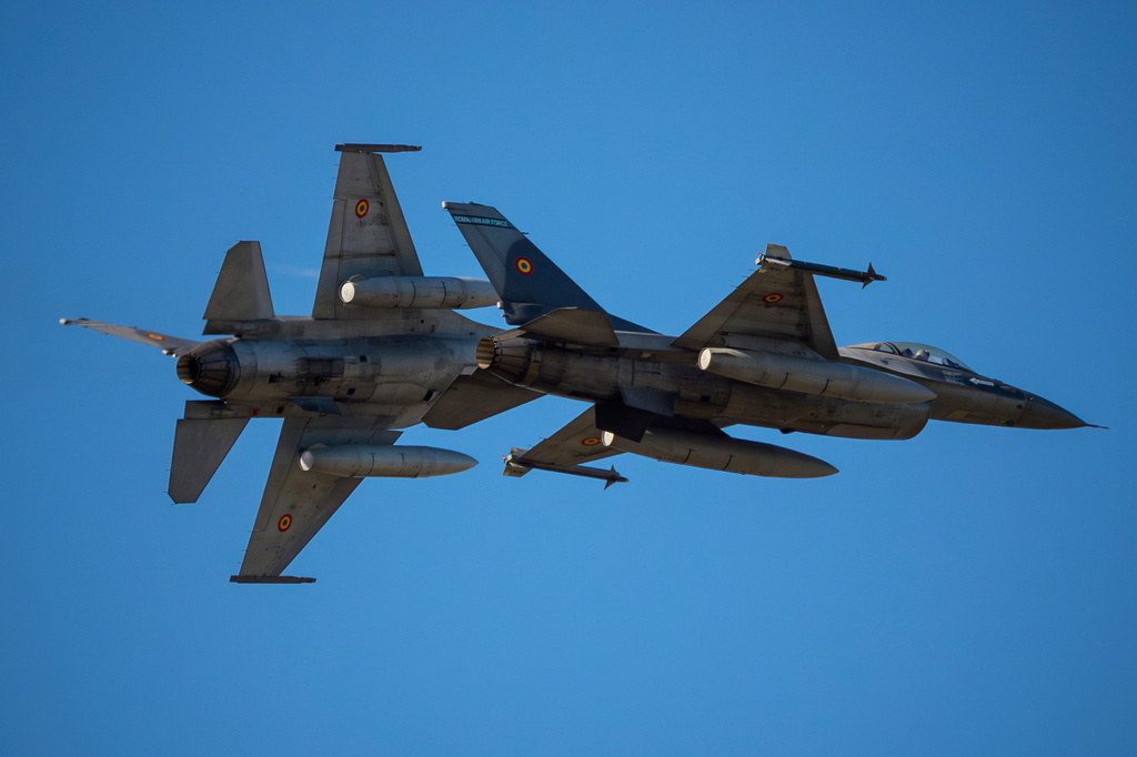 FILE - Pilots of the Romanian Air Force fly F-16 fighter jets above the runway of the Aurel Vlaicu airport, on the first day of the Bucharest International Air Show, BIAS, in Bucharest, Romania, Saturday, Aug. 30, 2025. (AP Photo/Andreea Alexandru, File)