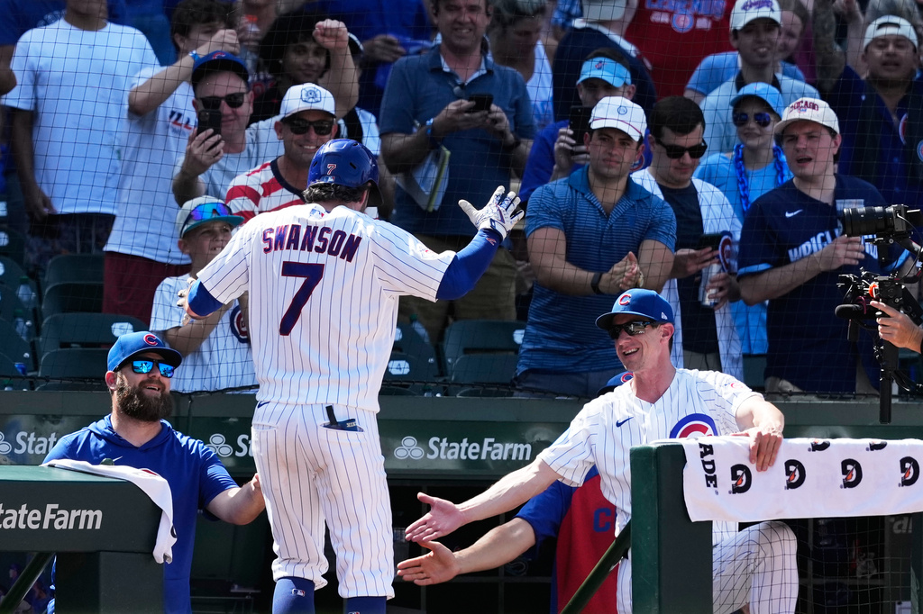 Chicago Cubs' Dansby Swanson (7) is congratulated by manager Craig Counsell, right, after hitting a grand slam during the eighth inning of a baseball game against the San Diego Padres in Chicago, Wednesday, July 1, 2026. (AP Photo/Nam Y. Huh)