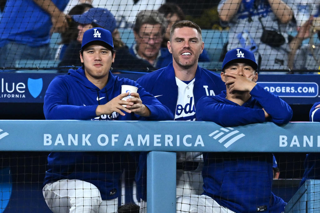 Los Angeles Dodgers' Shohei Ohtani, left, looks on during the ninth inning of a baseball game against the Washington Nationals, Friday, Sept. 4, 2026, in Los Angeles. (AP Photo/William Liang)