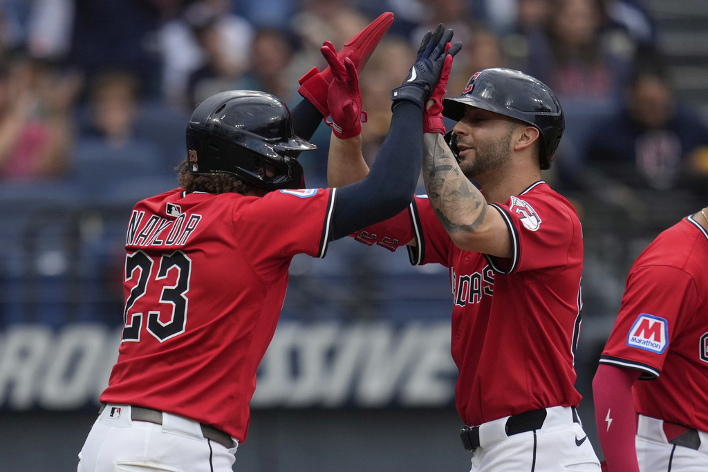 Cleveland Guardians' CJ Kayfus, right, is greeted at the plate by catcher Bo Naylor (23) after his home run in the second inning of a baseball game against the Chicago White Sox in Cleveland, Saturday, Sept. 13, 2025. (AP Photo/Sue Ogrocki)