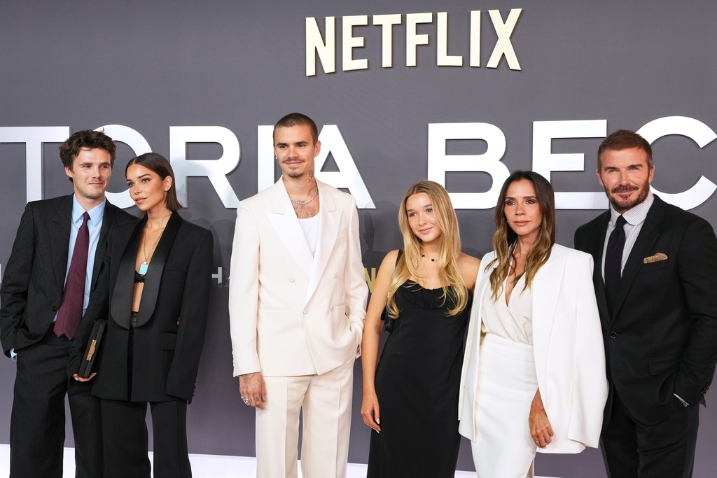 Cruz Beckham, from left, Jackie Apostel, Romeo Beckham, Harper Beckham, Victoria Beckham and David Beckham pose for photographers upon arrival at the premiere of the television series "Victoria Beckham" in London, Wednesday, Oct. 8, 2025. (Photo by Scott A Garfitt/Invision/AP)