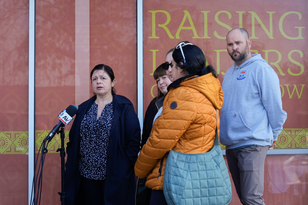 Maria Guzman, left, and other parents of young children speak outside of Rayito de Sol Spanish Immersion Early Learning Center after an employee of the preschool was arrested by federal immigration agents, Wednesday, Nov. 5, 2025, in Chicago. (AP Photo/Erin Hooley)