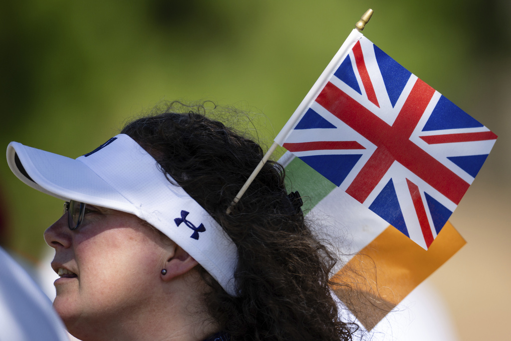 A women wears flags from Great Britain and Ireland during Walker Cup golf matches at Cypress Point Club, Saturday, Sept. 6, 2025, in Pebble Beach, Calif. (AP Photo/Thien-An Truong)