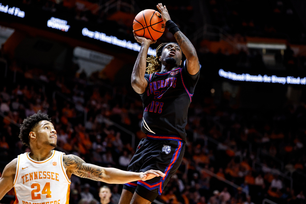 Tennessee State forward Aaron Nkrumah (30) shoots past Tennessee guard Troy Henderson (24) during the second half of an NCAA college basketball game Thursday, Nov. 20, 2025, in Knoxville, Tenn. (AP Photo/Wade Payne)