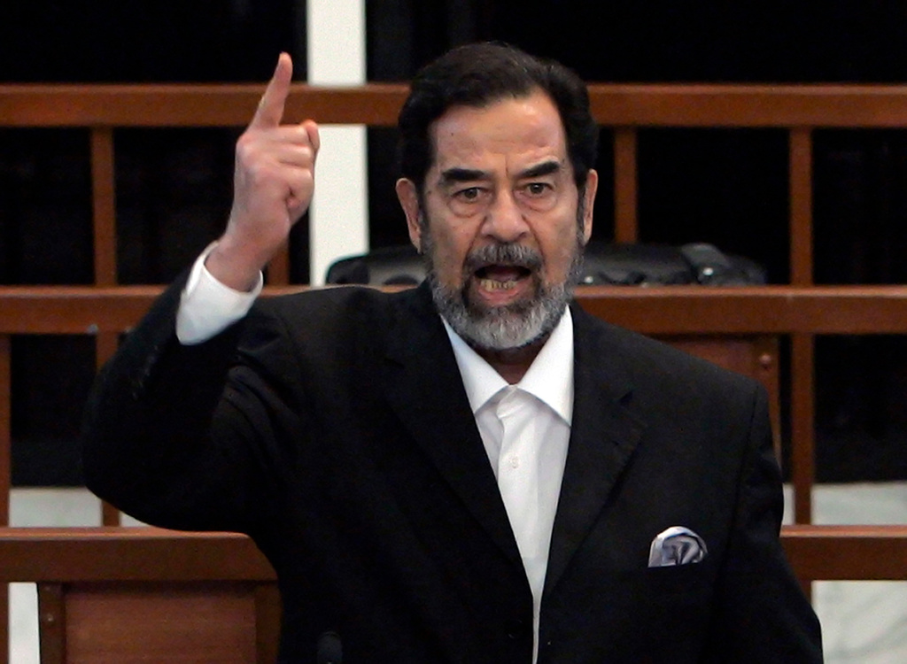 FILE - Former Iraqi president Saddam Hussein yells at the court as the verdict is delivered during his trial held under tight security in Baghdad's heavily fortified Green Zone, Sunday Nov. 5, 2006. (AP Photo/David Furst, Pool, File)