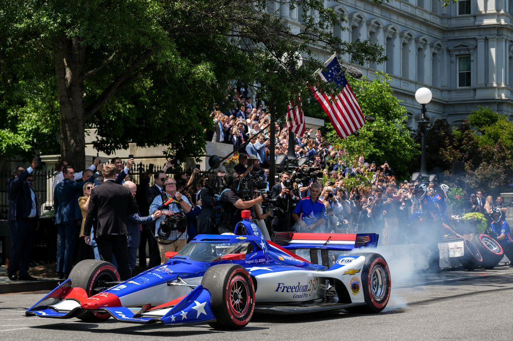 IndyCar Series driver David Malukas drives a race car down West Executive Drive during an event with President Donald Trump to promote the upcoming Freedom 250 Grand Prix auto race, Monday, July 13, 2026, at the White House in Washington. (AP Photo/Julia Demaree Nikhinson)