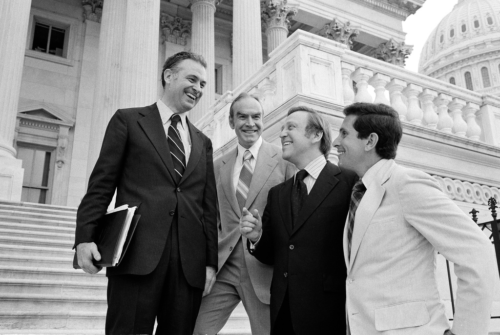 FILE - Rep. Lee Hamilton, D-Ind., Rep. Jim Wright, D-Texas, Rep. John Brademas, D-Ind., and Stephen Solarz, D-N.Y., stand on the steps of the House of Representatives following a vote, Aug. 2, 1978, in Washington. (AP Photo/John Duricka, File)