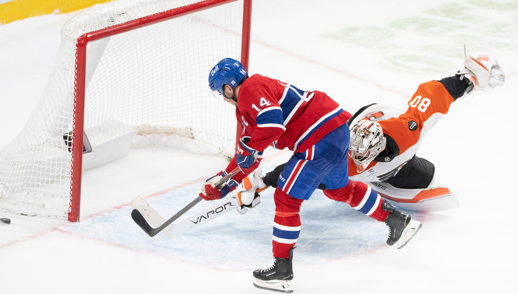 Philadelphia Flyers goaltender Dan Vladar (80) stops a shot by Montreal Canadiens' Nick Suzuki (14) during shootout NHL hockey action in Montreal on Tuesday, Nov. 4, 2025. (Christinne Muschi/The Canadian Press via AP)