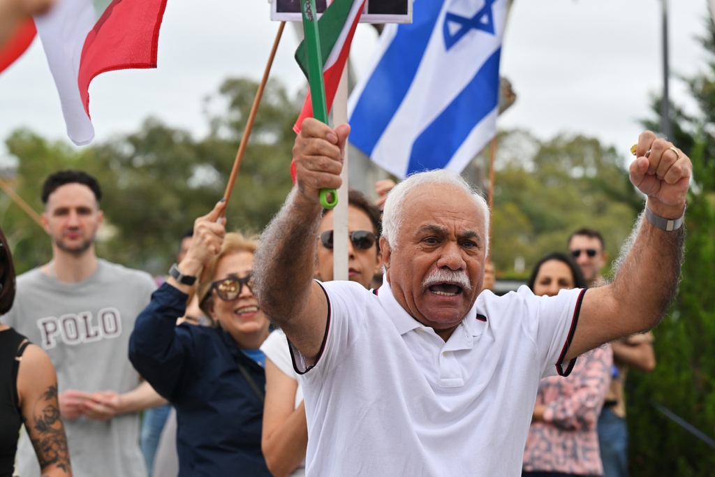 Iranian Australians react outside Iran's embassy in Canberra, Australia, Sunday, March 1, 2026. (Mick Tsikas/AAP Image via AP)