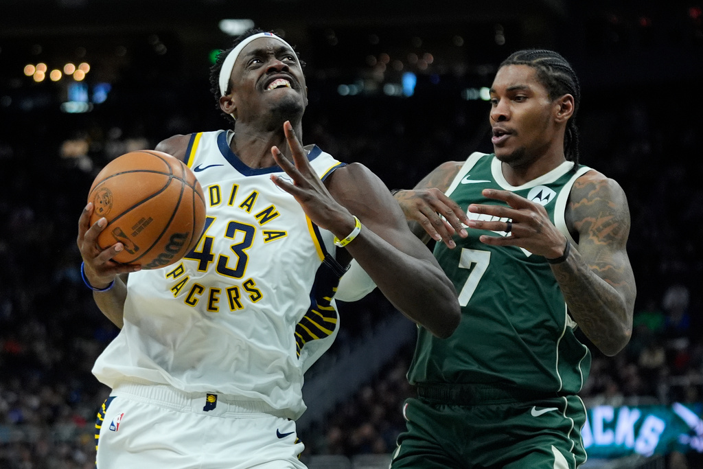 Indiana Pacers' Pascal Siakam (43) drives to the basket against Milwaukee Bucks' Kevin Porter Jr. (7) during the first half of an NBA basketball game Friday, Feb. 6, 2026, in Milwaukee. (AP Photo/Aaron Gash)