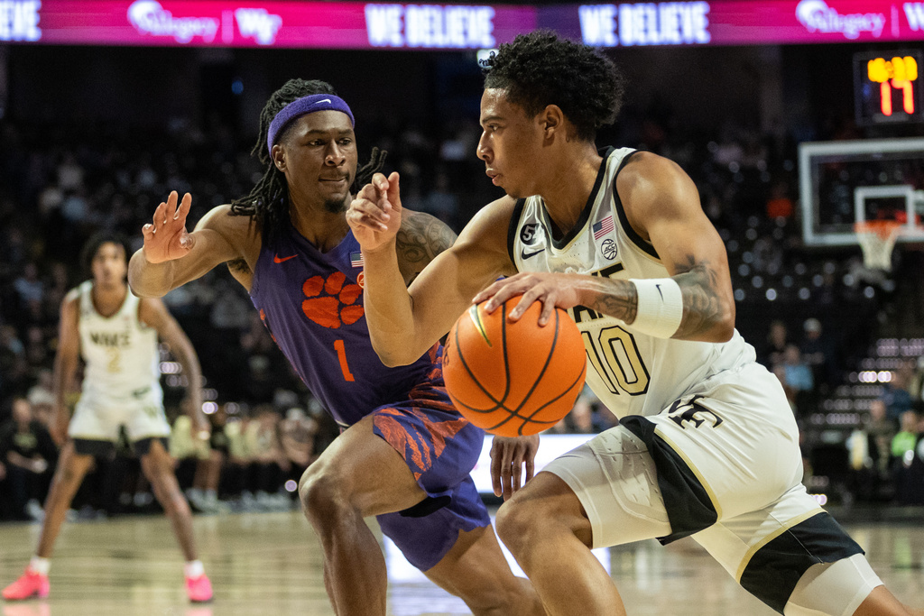 Wake Forest guard Sebastian Akins (10) drives to the basket past Clemson guard Jestin Porter (1) during the first half of an NCAA college basketball game Wednesday, Feb. 18, 2026, in Winston-Salem, N.C. (AP Photo/Scott Kinser)
