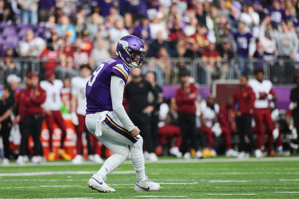 Minnesota Vikings quarterback J.J. McCarthy (9) reacts after throwing a touchdown during the second half of an NFL football game against the Washington Commanders, Sunday, Dec. 7, 2025, in Minneapolis. (AP Photo/Matt Krohn)